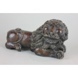 A carved wood figure of a recumbent lion, 22cm, (NC)