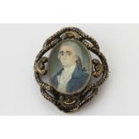 A portrait miniature of a gentleman, English school circa 1775, in a black enamelled brooch mount