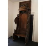 An unusual Victorian carved oak Archbishop's chair, the high panelled back with carved canopy and