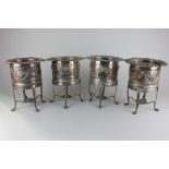 A set of four Victorian silver plated bottle coasters with floral swag and scroll decoration and