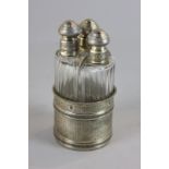 A Continental silver three glass scent bottle set, probably French, with screw tops and stoppers,