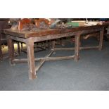 A 20th century oak Gothic style refectory table with 7cm thick plank top on eight moulded square