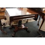 A William IV mahogany sofa table with shaped drawer on turned leaf pillar support, quatrefoil base