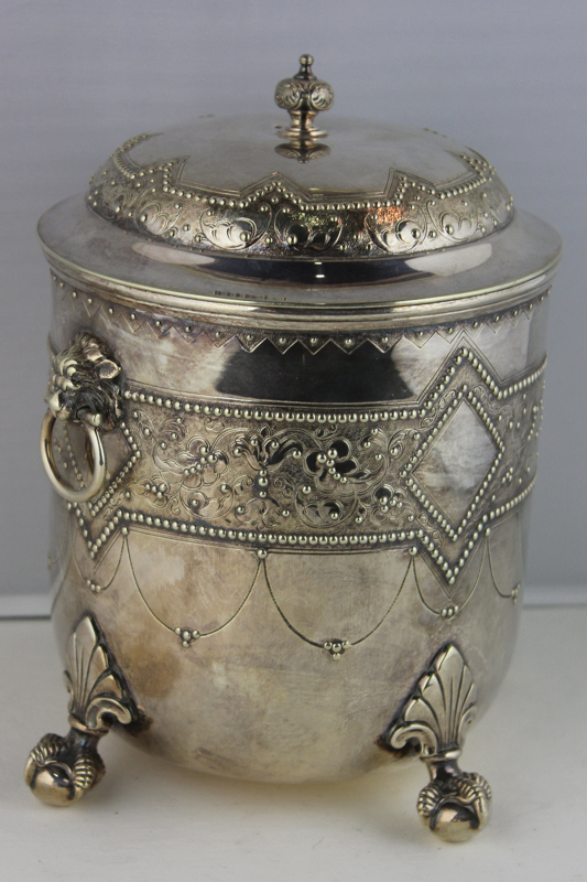 A silver plated ice bucket, raised floral and diamond banding with lion and ring handles, on claw