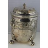 A silver plated ice bucket, raised floral and diamond banding with lion and ring handles, on claw