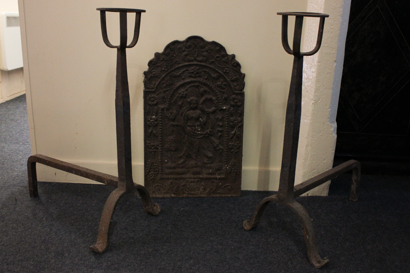 A cast iron fireback, cast with standing figure holding a bushel and wreath, 25cm high together with