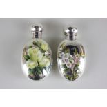 Two Victorian silver and enamel oval scent bottles, one monogrammed and enamelled with roses, the