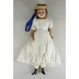 A late 19th century wax head and shoulder doll with short hair, fixed blue eyes and wax arms, in