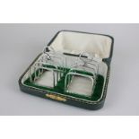 A cased pair of silver toast racks, maker Edward and Sons Ltd, Birmingham 1926, 3oz