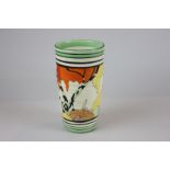 A Clarice Cliff Bizarre hand painted vase decorated with a landscape with banded rim and base,