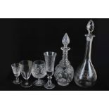 Two cut glass decanters with associated stoppers, four cut glass champagne flutes, together with