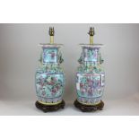 A pair of Chinese famille vert vases, now as table lamps, decorated in bright colours, the panels