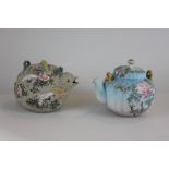 A Japanese pottery teapot modelled as a bird with raised painted decoration of storks and