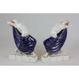 A pair of Royal Dux, Art Deco porcelain figures of nudes, the women arched back on cracking