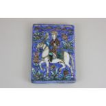 A Persian earthenware tile depicting a nobleman on a horse with a hawk in a mountain landscape, 13.