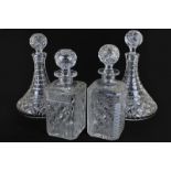 A pair of cut glass ships decanters together with a pair of cut glass spirit decanters (different