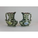 A pair of Exeter slipware pottery jugs, green glaze over brown ground with cream detail, 20cm high