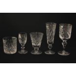 A set of six cut glass champagne flutes, six wine glasses and six aperitif glasses, together with