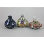 Three Cobridge pottery stoneware vases decorated with naturalistic designs, including a trial vase