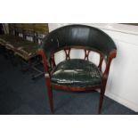 A tub shaped desk chair with leather back and seat, with open sides, on tapered legs (NC)