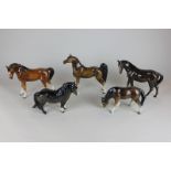 A Beswick mare  facing left (976) and a Beswick Shetland pony (1033), together with three other