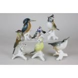 Six Karl Ens porcelain ornaments of birds including kingfisher, robin and cuckoo, and a tree