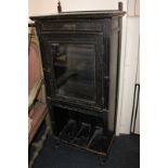 A Victorian ebonised music cabinet with single drawer above glazed door, on canterbury base,