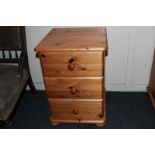 A pine bedside chest of three drawers, on ball feet, 42.5cm