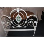 A cast iron bedstead painted white with hand painted floral panels 122.5cm by 182cm (NC)