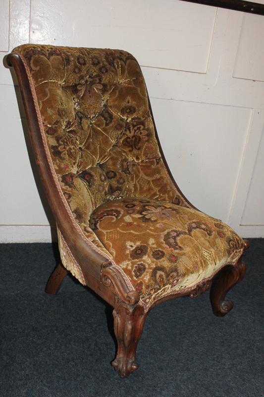 An oak framed nursing chair with button back upholstery, on cabriole legs