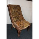 An oak framed nursing chair with button back upholstery, on cabriole legs