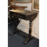 A Victorian chinoiserie ebonised work table with rectangular rising top enclosing fitted