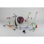 A group of twelve glass animal ornaments including an octopus, two cats, a frog, a snake, a lobster,