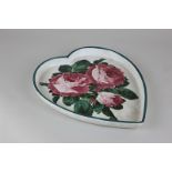 A Wemyss pottery dish in the shape of a heart, decorated with cabbage roses, originally sold by T