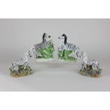 Two pairs of Staffordshire pottery zebra figures