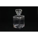 A plain cut glass square spirit decanter with octagonal faceted stopper