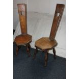 Two mahogany spinning chairs, highly decorated with inlay showing flowers in a vase and Cupid