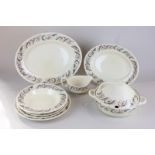 A Susie Cooper part dinner service comprising two graduated platters, two vegetable tureens with