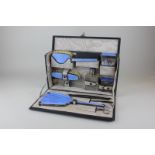 An Edward VIII Art Deco silver travelling dressing set with blue enamel decoration comprised of