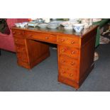 A Victorian oak pedestal desk with green leather inset top over one long and two short drawers,
