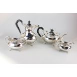 A silver plated four piece tea and coffee set with plain bodies, scalloped edging and ebonised