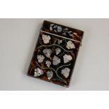 A Victorian tortoiseshell card case with inlaid mother of pearl floral and vine leaf decoration