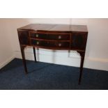 A Williamson, Guildford, walnut and mahogany serpentine writing table, two top flaps opening onto