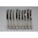 A set of nine Edwardian silver handled butter knives, Sheffield 1906 (marks rubbed), the blades