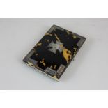 A Victorian tortoiseshell purse with unmarked silver inlay corners and central cross shaped
