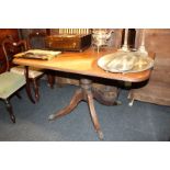 A late Regency mahogany breakfast table with tilting top on turned column base, 125cm by 44cm (NC)