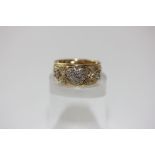 An 18ct yellow gold ring pave set with heart shaped clusters of eight cut diamonds, 4.7g gross