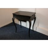 A Vedder Paris ebonised dressing table, the lift-up top revealing a mirror over a sliding section,