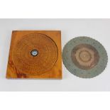 A Chinese circular wooden compass, 16cm, in fitted square case, 19cm, and metal disc calendar, (