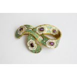 A 19th century gold, amethyst and green and white enamel ribbon brooch with glazed hair compartment